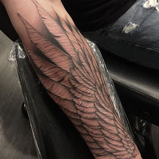 Forearm black and grey Tattoo done by Tattoo Artist Alan Lott of Wings. Intricate clean lines form the feathers of this custom tattoo. Alan Lott is available for custom tattoos in the Triangle of North carolina (Raleigh, Durham, Chapel Hill) at Custom Tattoo Parlor and Art Gallery, Sacred Mandala Studio.